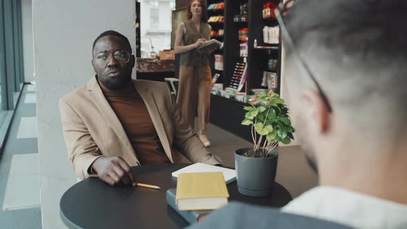 Business Partners Talking in Library