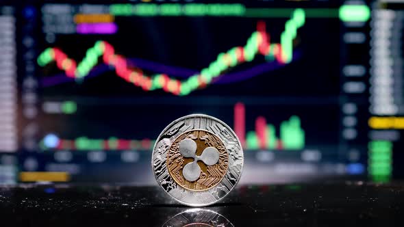 Coin Ripple XRP on background cryptocurrency trading chart on computer screen