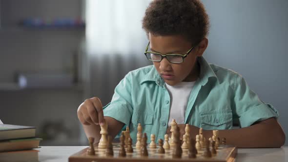 African American Boy Logically Thinking Out Strategy of Playing Chess, Hobby