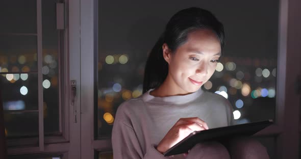 Woman use of tablet computer at night