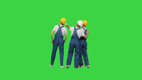 Laborers Standing Looking at the Construction Site on a Green Screen, Chroma Key.