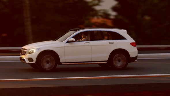 White Luxury SUV Progressing On Forest Road