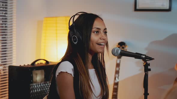 Closeup of Beautiful Smiling Girl in Headphone Singing Her Favourite Song on the Rehearsal