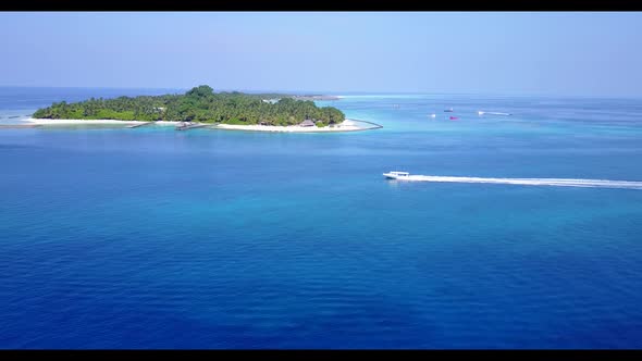 Aerial flying over nature of tropical coastline beach holiday by aqua blue water and white sandy bac