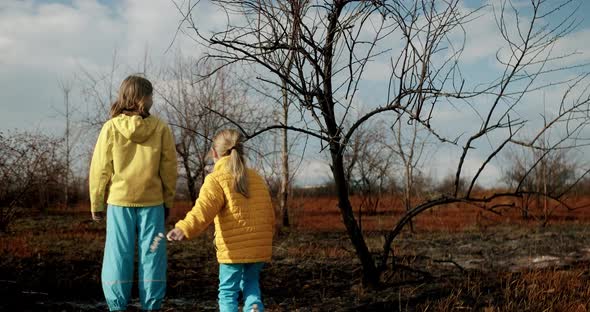 The Younger Sisters Dressed in the Colors of the Ukrainian Flag Embrace