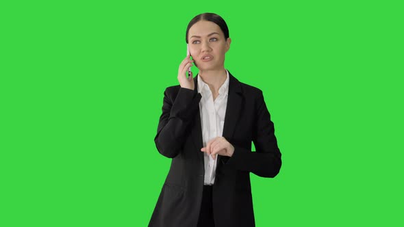 Bossy Businesswoman Talking on Her Phone on a Green Screen, Chroma Key.