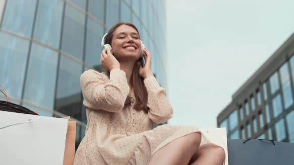 Woman Listening to Music and Beckoning