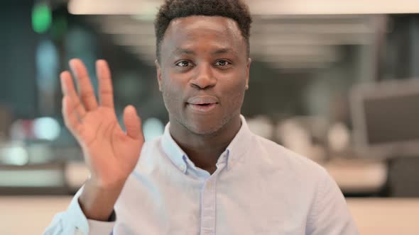 Portrait of African Businessman Waving Welcoming