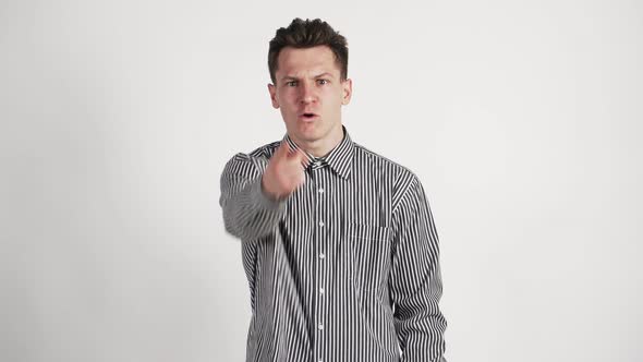 A Young Man of Caucasian Appearance and Angry Swears Directly To the Camera Waving His Hands