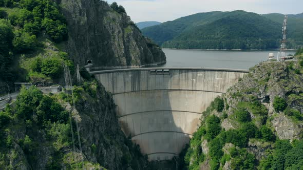 Aerial View of a Hydroelectric Dam in the Mountains Covered with Forest