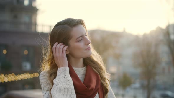 Gorgeous Girl Touching Hair Outdoors. Cute Woman Walking on City Street.