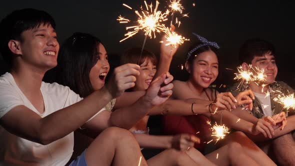 Young play fireworks on beach