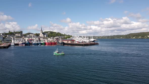 Drone shot of a small irish fishing boat coming into harbour.