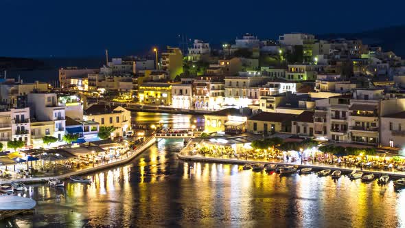 Night view timelapse of Agios Nikolaos town and Voulismeni lake at night, Crete, Greece