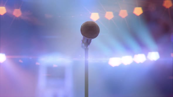 Microphone on the Stage in the Concert Hall Against the Shining Stage Lights
