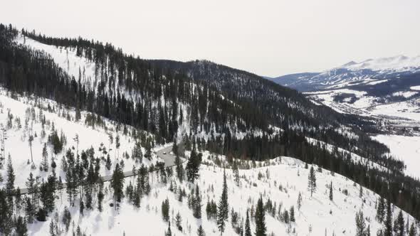 Mountain Road Winter Driving Cars Around Curve Aerial Landscape