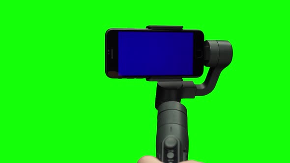 Hand Shooting Using Steadycam Gimbal Stabilizer with Blue Screen Smartphone