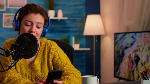 Famous Blogger with Headphones Streaming From Home Studio