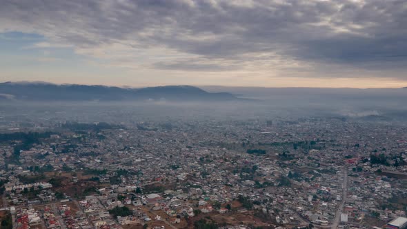 Static aerial hyperlapse of morning clouds and fog above Xela, Guatemala.