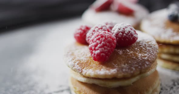 Video of pancakes on plate seen from above on wooden background