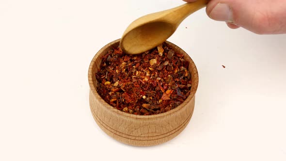 Chef Taking Spices Paprika or Chili Flakes From Wooden Spice Jar