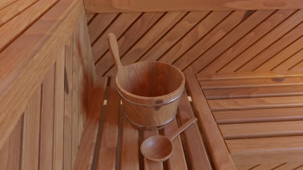Wooden Finnish sauna accessories. Water bucket with a wooden ladle in a bathroom
