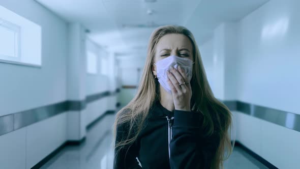 Woman Wearing Face Mask Because of Air Pollution or Virus Epidemic in the Hospital Corridor