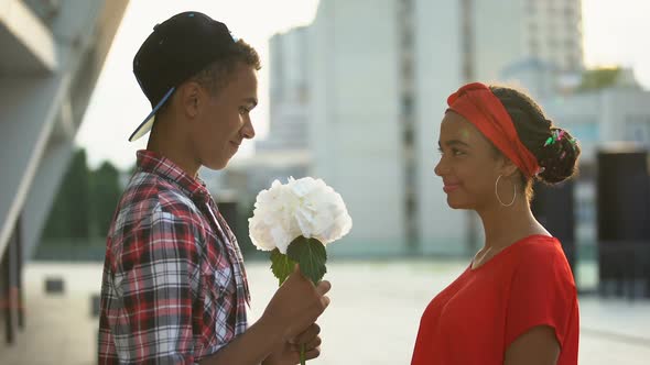 Teen Boy Giving Flowers to Beautiful Girl, Experiencing First Love, Romance