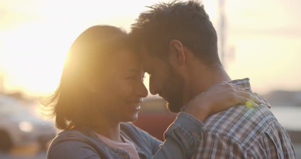 Happy Diverse Boyfriend and Girlfriend Hug Enjoying Spending Time Together Outdoors