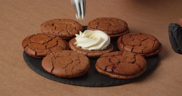 The Confectioner Applies Cream to the Cookies with the Help of Confectionery Accessories