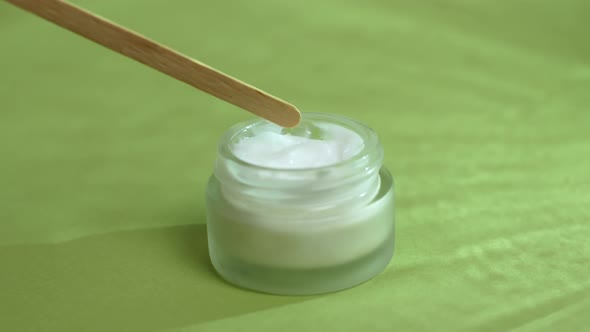 The concept of beauty and health and body skincare. Macro. Isolated on a green background.