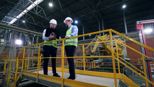 Male Engineers Work at a Modern Industrial Factory.