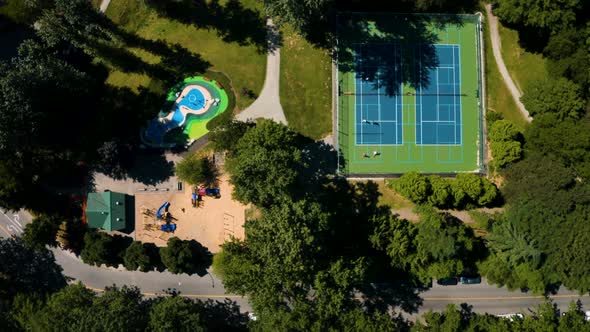 Top down aerial view over tennis courts and a playground in Burnaby, Greater Vancouver.