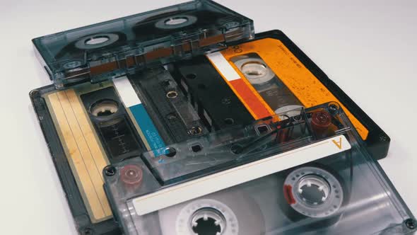 Four Audio Cassettes Rotate on White Background