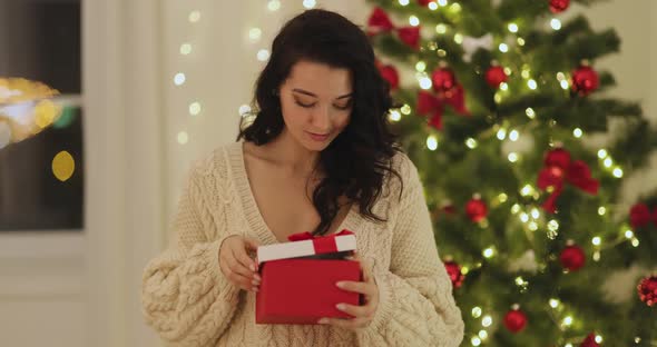 Woman With Present in the Gift Box Near Christmas Tree at Home