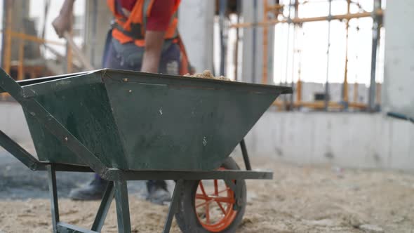 Workers Throw Sand Into the Cart