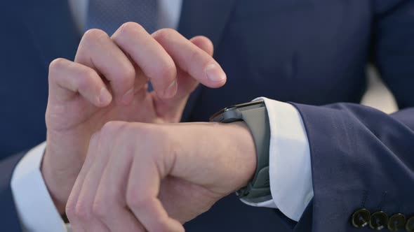 Close Up of Hands of Businessman Using Smartwatch