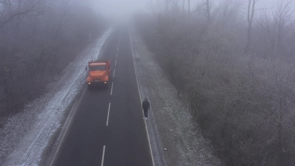 Big Orange Truck Driving Along the Road