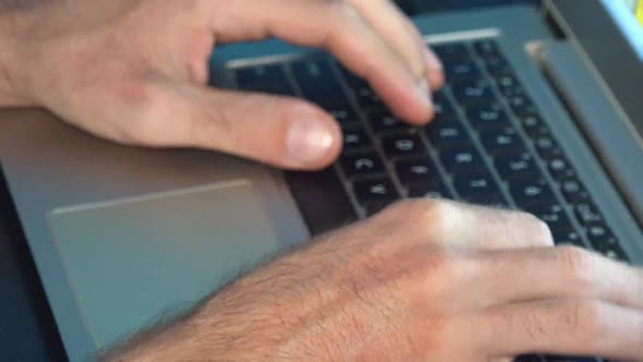 Close Shot of Male Hands Typing on a Laptop Computer