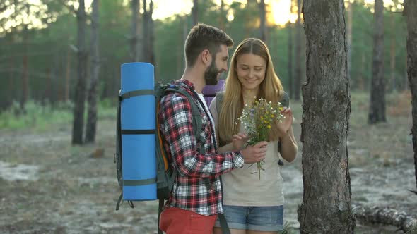 Husband Presenting Bouquet of Field Flowers to Wife