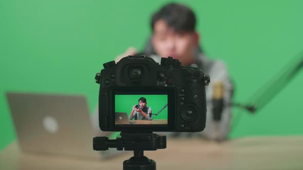 Camera Monitor Recording Asian Man With Computer Reviewing Camera Len On Green Screen