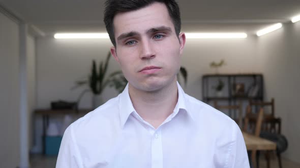 Portrait of Sad Businessman Looking at Camera