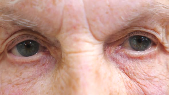 Portrait of Elderly Woman with Pensive Look. Old Woman Watching Pensive Into Camera and Closing Her