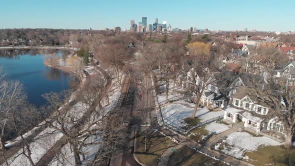 Aerial footage car driving on a street heading to downtown Minneapolis, suburbs on sunny day