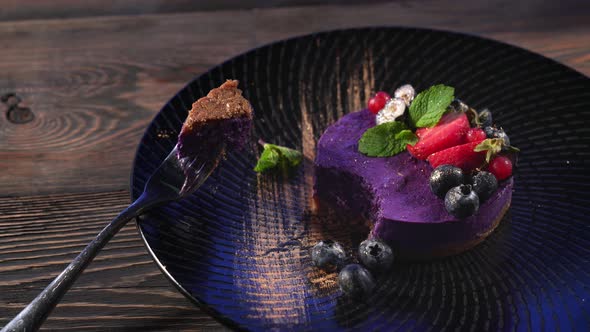 Piece of Purple Cheesecake on Fork.