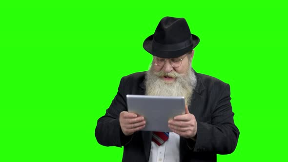 Funny Elderly Businessman Playing on Digital Tablet
