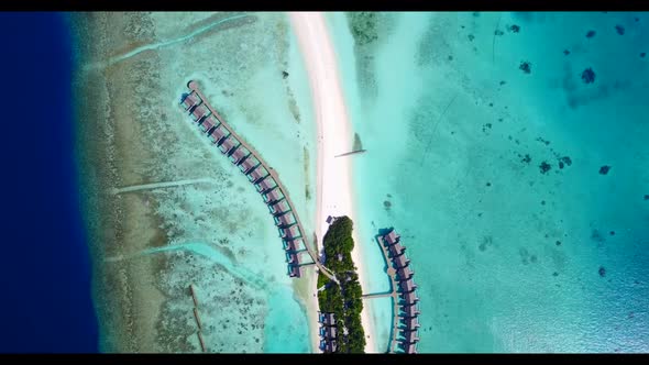 Aerial drone shot scenery of idyllic shore beach voyage by aqua blue lagoon and clean sand backgroun