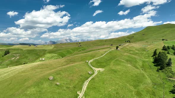 Dolomites Mountains with hiking paths and wooden cottages