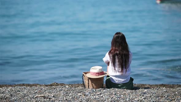 Young Woman in Hat on the Beach Vacation