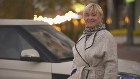 Successful Mature Business Woman Holding Keys of New Expensive Luxury Car